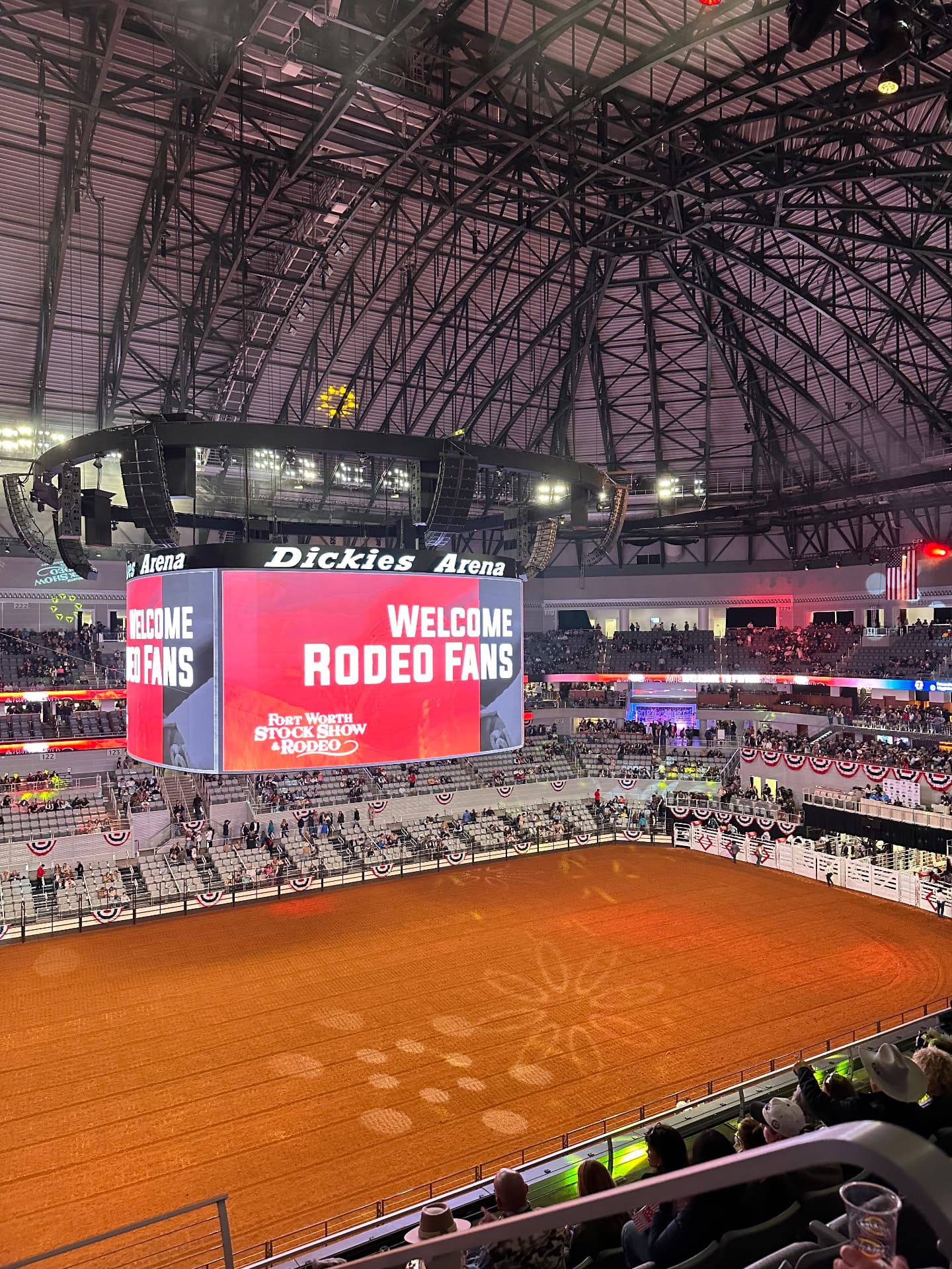 Packed arena at a western stock show and rodeo before the performance begins.