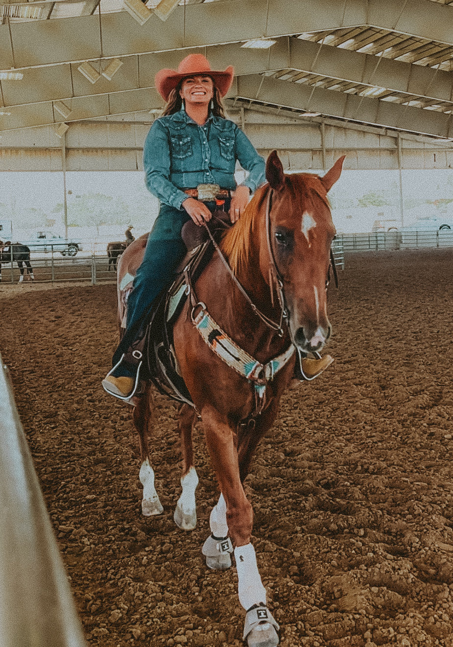 Rider working a horse in the arena at a western event.